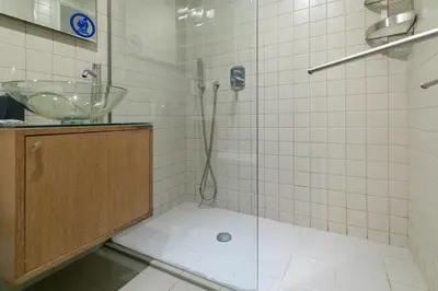 a bathroom with a sink and a glass shower at The studio in the heart of Athens-Plaka in Athens