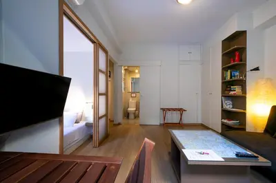 a living room with a couch and a tv at The studio in the heart of Athens-Plaka in Athens