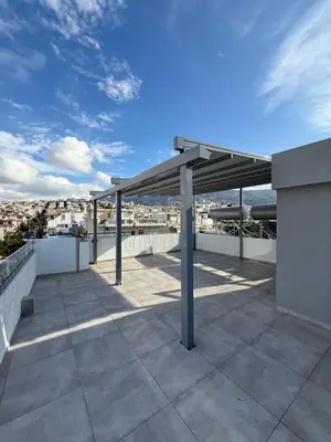 a pavilion on the roof of a building at M&H and their friends B in Athens