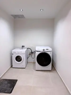 a laundry room with a washing machine and a washer at M&H and their friends B in Athens