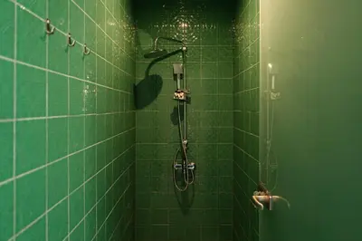 a green tiled shower in a green tiled bathroom at The Verve by Zoia Living in Athens