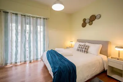 a bedroom with a bed and a large window at Mia Homes - Heart of Athens in Athens