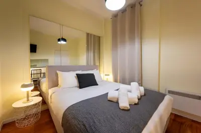 a bedroom with a bed with white towels on it at Mia Homes - Heart of Athens in Athens