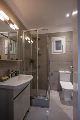 a bathroom with a shower and a sink and a toilet at Mia Homes - Heart of Athens in Athens