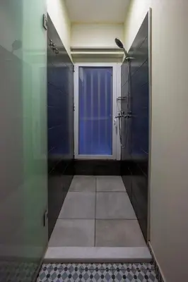 a bathroom with a shower and a door with a window at Mia Homes - Heart of Athens in Athens