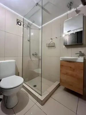 a bathroom with a toilet and a shower and a sink at Lux Downtown Kolonaki in Athens