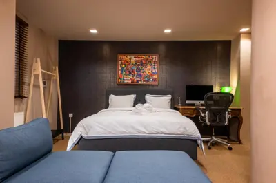 a bedroom with a bed and a desk with a computer at Lux Downtown Kolonaki in Athens
