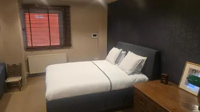 a bedroom with a large bed with white sheets and pillows at Lux Downtown Kolonaki in Athens