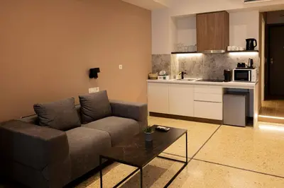 a living room with a couch and a kitchen at Belle Athenes Apartements in Athens