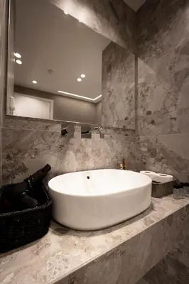 a large white tub in a bathroom with a mirror at Belle Athenes Apartements in Athens