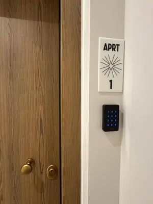 a door with an artichoke clock on it at Belle Athenes Apartements in Athens