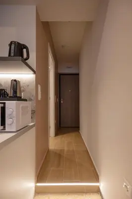 a hallway leading to a kitchen with a door at Belle Athenes Apartements in Athens