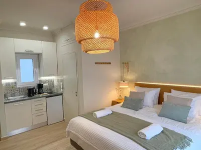 a bedroom with a large bed and a light at Athenian Boho Nest by 8essentially in Athens