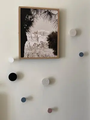 a picture hanging on a wall with dots at Athenian Boho Nest by 8essentially in Athens