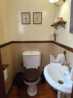 a bathroom with a toilet and a sink at Cleo's Garden House in Athens