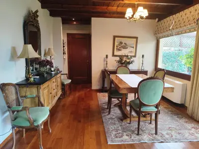 a dining room with a table and chairs at Cleo's Garden House in Athens