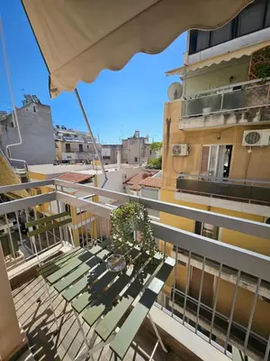 a balcony with a table and a building at LYT house at the foot of the Acropolis in Athens