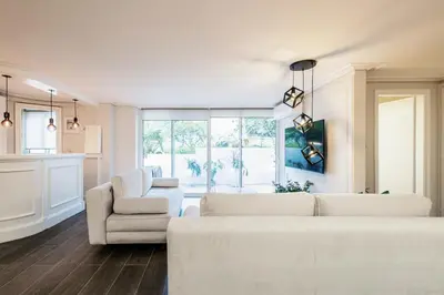a living room with white furniture and a large window at MZ Kolonaki Hills in Athens