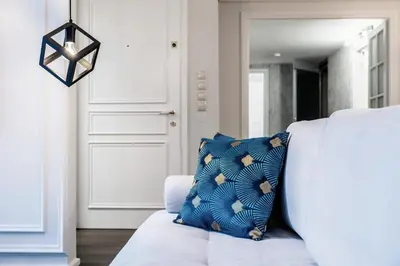 a bedroom with a white bed and a blue pillow at MZ Kolonaki Hills in Athens