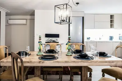 a dining room with a wooden table and chairs at MZ Kolonaki Hills in Athens