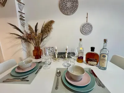 a table with plates and cups and wine bottles at Apartments Sunshine G1 in Athens