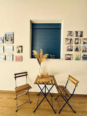 a table and two chairs in a room with a window at Apartments Sunshine G1 in Athens