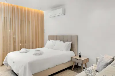 a bedroom with a white bed and a window at Athenian Harmony Parliament Square Athens Centre in Athens