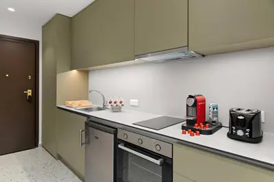 a kitchen with a red appliance on a counter at Athenian Harmony Parliament Square Athens Centre in Athens