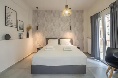 a bedroom with a large bed and a large window at The Suite by Spaceers in Athens