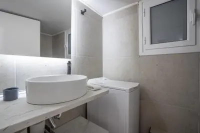 a white bathroom with a sink and a toilet at The Suite by Spaceers in Athens