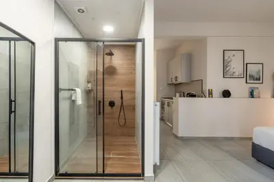 a bathroom with a shower and a kitchen at The Suite by Spaceers in Athens