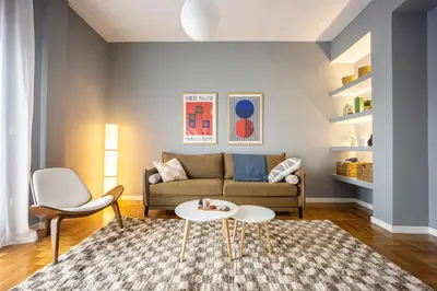 a living room with a couch and a table at 2BR Family Apt for 6 and a Large Sunny Balcony in Athens