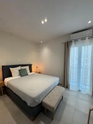 a bedroom with a large bed and a window at Reservoir Athens in Athens