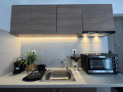 a kitchen with a sink and a microwave at Reservoir Athens in Athens