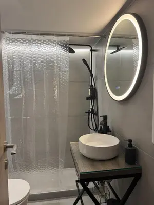 a bathroom with a sink and a shower with a mirror at Reservoir Athens in Athens