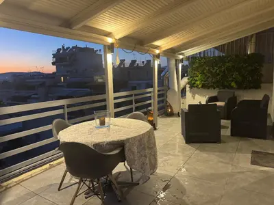 a table and chairs on a balcony with a view at Reservoir Athens in Athens