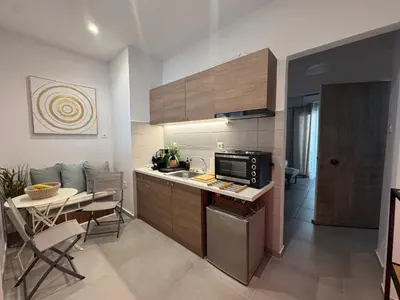 a kitchen with a sink and a table with a dining room at Reservoir Athens in Athens