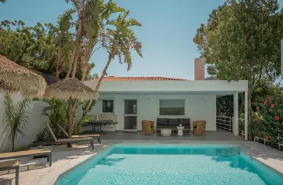 a villa with a swimming pool and a house at El Mar, Pool House with 3 BDR, 7 min from beach in Saronida