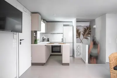 a white kitchen with white cabinets and a sink at El Mar, Pool House with 3 BDR, 7 min from beach in Saronida