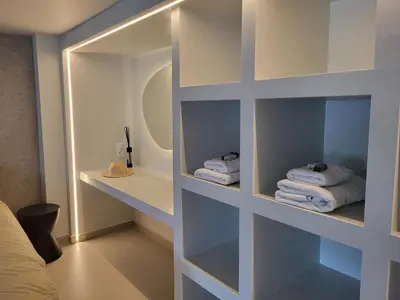a room with white shelves with towels in it at El Mar, Pool House with 3 BDR, 7 min from beach in Saronida