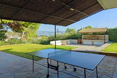 a ping pong table sitting under a pavilion in a yard at Summer Breeze villa in Saronic Gulf in Anavissos