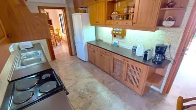 an empty kitchen with a stove and a refrigerator at Summer Breeze villa in Saronic Gulf in Anavissos