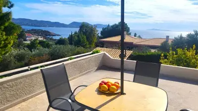 a bowl of fruit sitting on a table on a balcony at Summer Breeze villa in Saronic Gulf in Anavissos