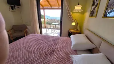 a bedroom with a pink bed with a view of a balcony at Summer Breeze villa in Saronic Gulf in Anavissos