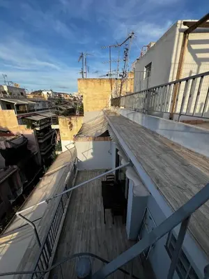 a balcony of a building with a chair on it at Penthouse Athens centre-Skythens in Athens