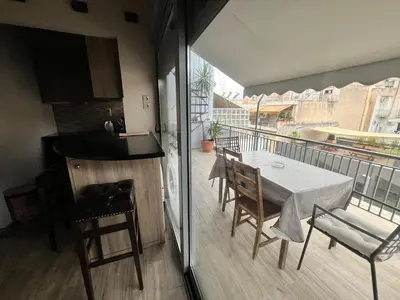 a kitchen with a table and chairs on a balcony at Penthouse Athens centre-Skythens in Athens