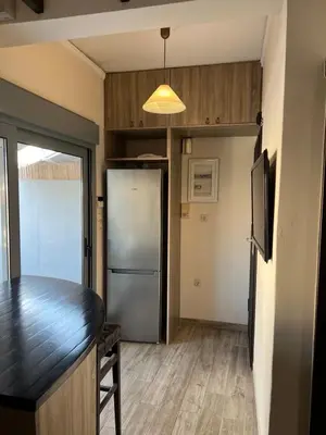 a kitchen with a black counter and a refrigerator at Penthouse Athens centre-Skythens in Athens