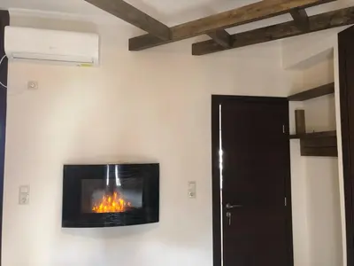 a fireplace in the corner of a room at Penthouse Athens centre-Skythens in Athens