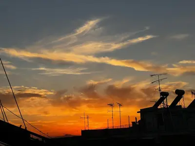 a sunset with clouds in the sky at Penthouse Athens centre-Skythens in Athens