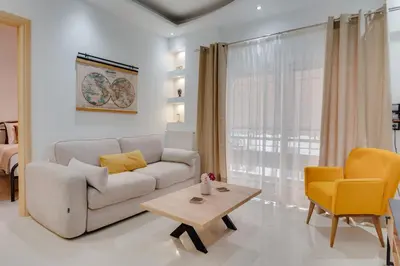 a living room with a couch and a table at Stefanos flat in the heart of Koukaki 2BD in Athens